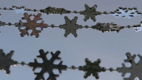 Toy snowflakes waving in the wind, a cold day. conveys an exciting mood. Stock Footage 82605130
