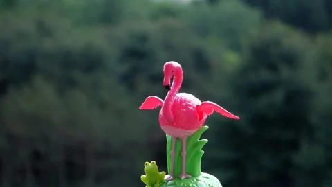 Toy Solar Powered Dancing Pink Flamingo On A Green Background 動画素材 90313136