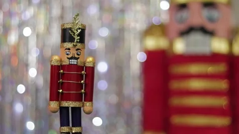 Toy soldier nutcracker next to same huge figurine in bokeh background. Stock Footage 259316905