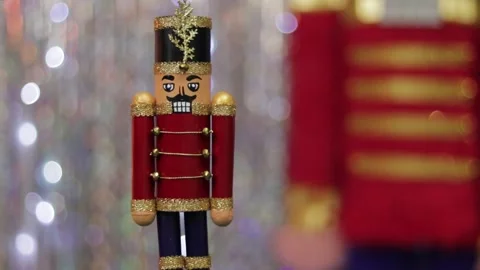 Toy soldier nutcracker on table, same but huge figurine in background. Stock Footage 259315584