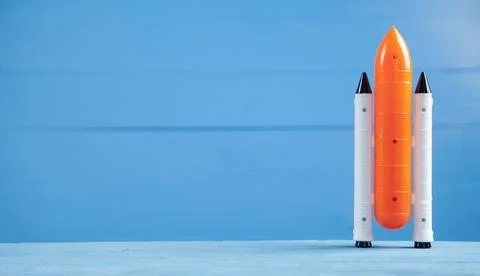 Toy space shuttle on blue background. Rocket launch Stock Photos