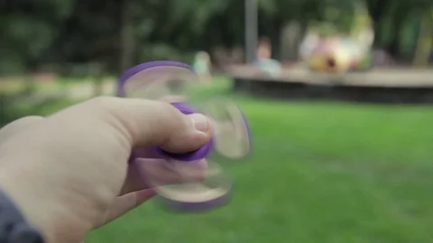 Toy spinner in hand, shot close-up. Stock Footage 77708628