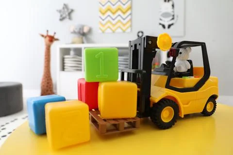 Toy stacker and cubes on table in child's room, closeup Stock Photos