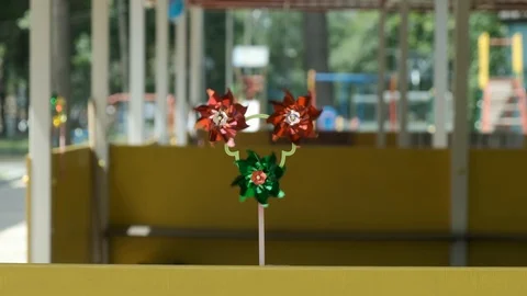 Toy on a stick windmill, spinner. The wind blows, the flowers rotate. Stock Footage 117410871
