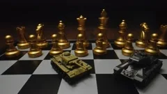 Toy tanks with chess on chessboard. Concept of military strategy., Stock  image