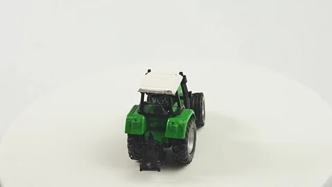 Toy tractor on a white background, the concept of agricultural work Vídeo Stock 151197508