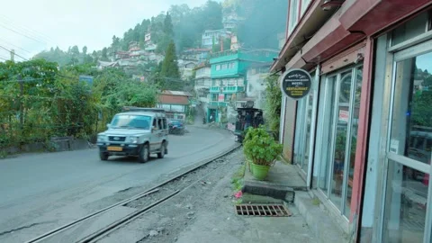 Toy Train Passing Through Town Street of Darjeeling, India on 15th August, 2025 Stock Footage 323995899