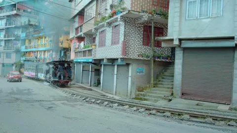 Toy Train Running Along Roadside in Darjeeling, India on 12th August 2025 Stock Footage 323925308