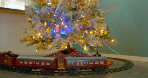 Toy Train Under Christmas Tree Tracking Shot Stock Footage 296145044