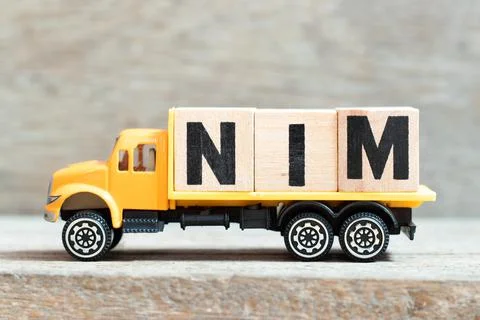 Toy truck hold alphabet letter block in word NIM (Abbreviation of Net interes Stock Photos