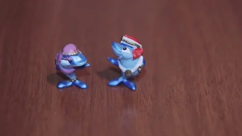Toy two blue dolphins on a dark background cartoon mini Stock Footage 71889665