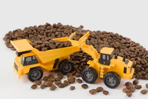 Toy vehicles work with coffee beans Stock Photos