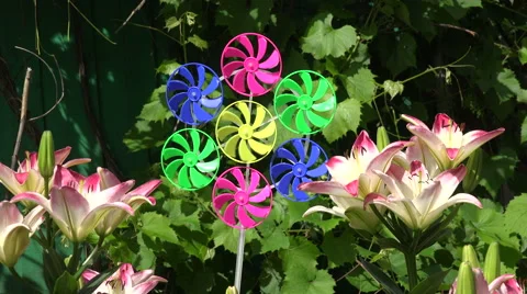 Toy windmill between lilies, 4 K Stockbeeldmateriaal 64705601