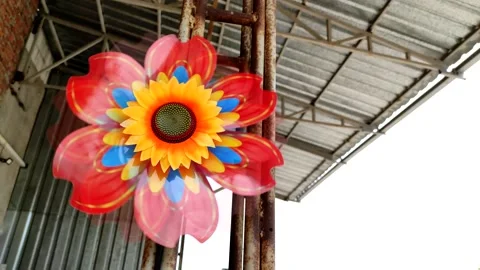 Toy windmill in the shape of a sunflower. Concept alternative energy. Stock Footage 156680290