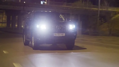 Toyota Land Cruiser Prado Car Drives at Night On City Streets Stock Footage