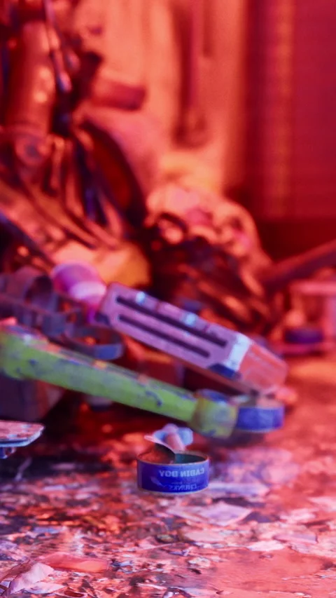 Toys and tools scattered on table in colorful lighting during evening time Stock Footage 331762370