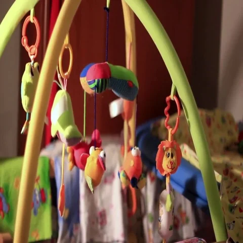 Toys hanging in the crib Stock Footage 69704219