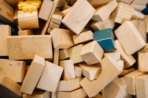 Toys in kindergarten. Chaotically scattered wooden blocks Stock Photos