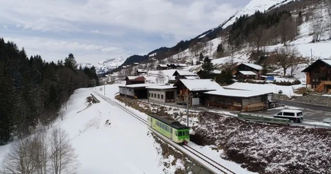 TPC train going out of Les Diablerets - Aerial 4K Stock Footage 104593874
