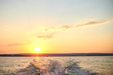 Trace from a boat on the river at sunset. Stock Photos