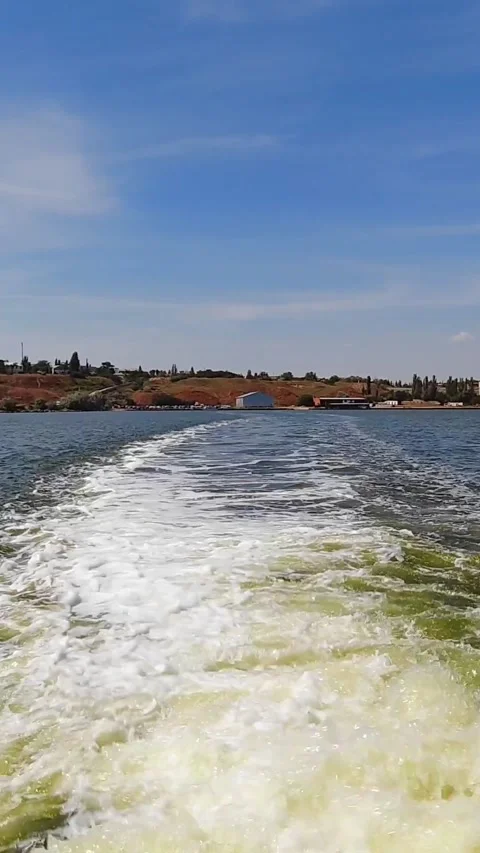 The trace of a boat on the water, which moves away from the shore. Hyperlapse Stock Footage 274136366