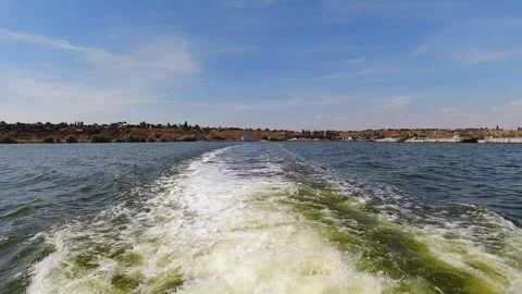 The trace of a boat on the water, which moves away from the shore. Hyperlapse Stock Footage 284085159