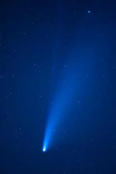 Trace of a comet or shooting star in a blue starry sky with stars in the nigh Stock Photos