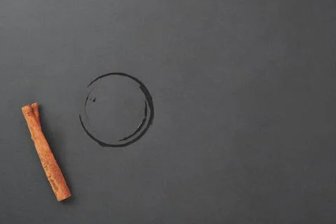 Trace from a cup on a black background in the form of a face. Empty space. Stock Photos