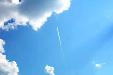 Trace from the plane in the blue sky with clouds Stock Photos
