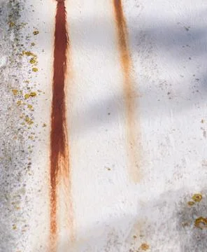 Trace of rust on an old white wall Stock Photos