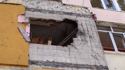 Traces of an artillery shell hitting a multi-storey residential building. Part Stock Footage 247547727