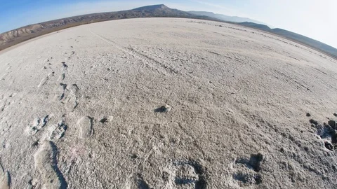 Traces on the bottom of a dried lake with a convex horizon line fisheye Stock Footage 99728947