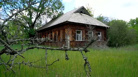 Traces of destruction by time. Wooden house in the Chernobyl Exclusion Zone Stock Footage