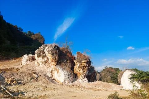 Traces of karst mountain mining are visible, featuring white rock. Stock Photos