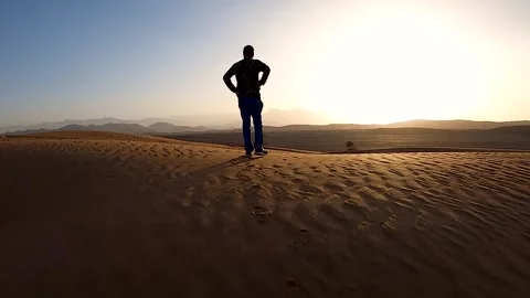 Tracing the footsteps of a man in Desert Stock Footage 138756473