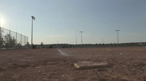 Track across a baseball field while kids warm up Stock Footage 41669989