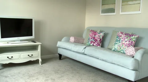 Track back and forth past TV towards sofa in living room Stock Footage 35603350