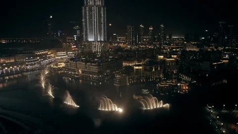 Track back while ascending from 100m to 200m behind Burj Khalifa, looking down Stock Footage 98964705