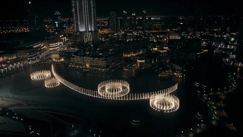 Track back while ascending from 100m to 200m above Dubai Fountain, night. Stock Footage 98973408