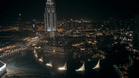 Track back while ascending from 200m to 300m behind Burj Khalifa, looking down Stock Footage 98963450