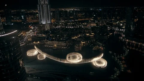 Track back while ascending from 200n to 300m behind Burj Khalifa, looking down Stock Footage 98974889