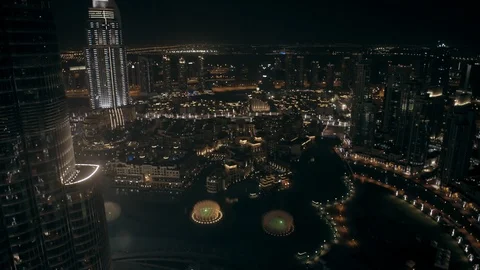 Track back while ascending from 300m to 400m behind Burj Khalifa, looking down Stock Footage 98965251