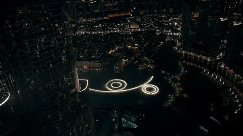 Track back while ascending from 300m to 400m behind Burj Khalifa, looking down Stock Footage 98975502