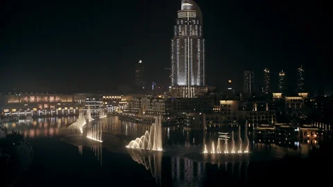 Track back while ascending from 30m to 100m behind Burj Khalifa, looking down at Stock Footage 98963419