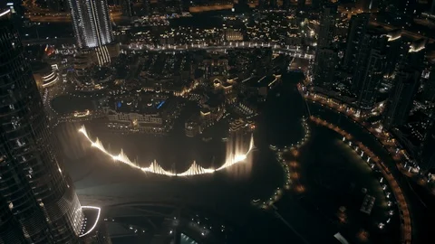 Track back while ascending from 400m to 500m behind Burj Khalifa, looking down Stock Footage 98965422