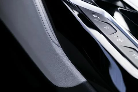Track control buttons near automatic gear stick in a white leather interior.. Stock Photos