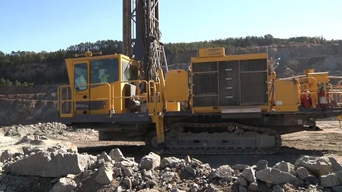 Track drilling machine in granite quarry Stock Footage 97959474