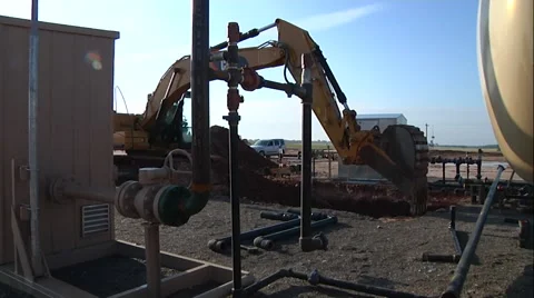 Track Hoe Digging Around oil Equipment Stock-Footage 44267535