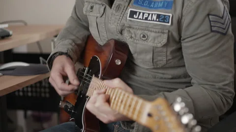 Track left and right of man playing electric guitar Stock Footage 50243895