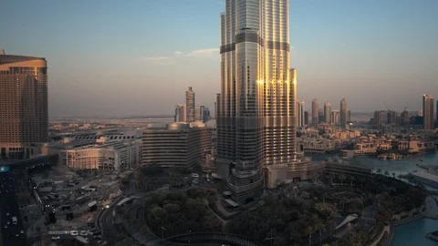 Track left past base of Burj Khalifa at 60m to reveal Dubai Mall, The Address Stock Footage 98948806